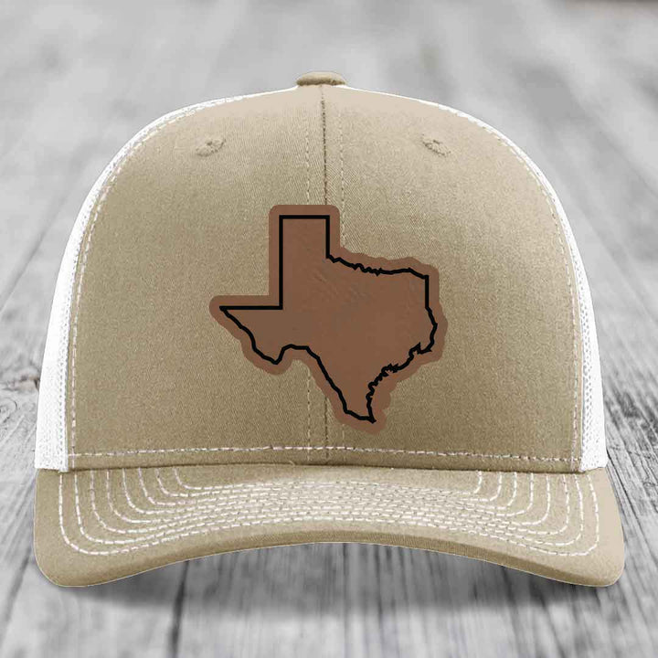 Tan trucker hat with brown leather Texas state patch outlined in black.