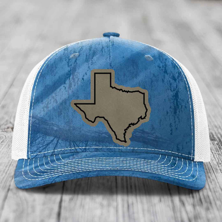 Blue and white trucker hat with a tan Texas state outline patch on the front.