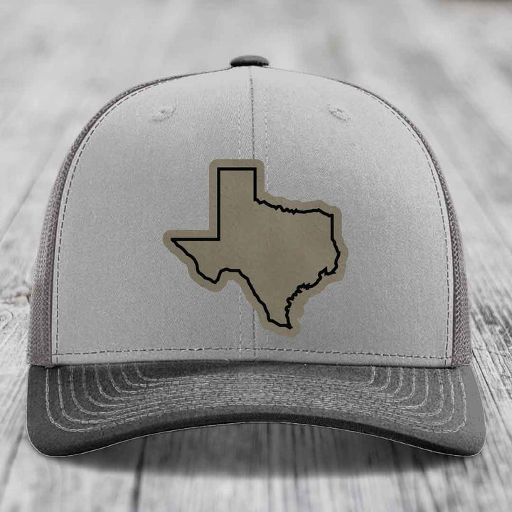 Grey trucker hat with black-stitched Texas state outline patch on front.