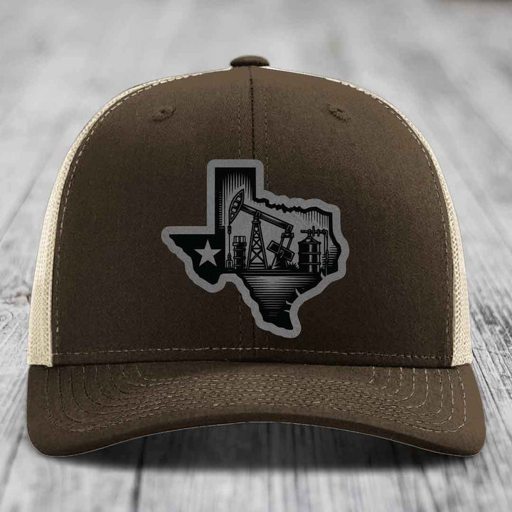 Brown trucker hat with Texas oilfield patch featuring pumpjacks and star outline.