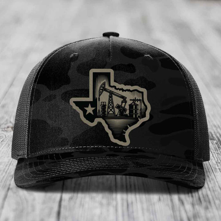 Black camouflage trucker hat with tan Texas oilfield patch featuring pumpjacks and star.
