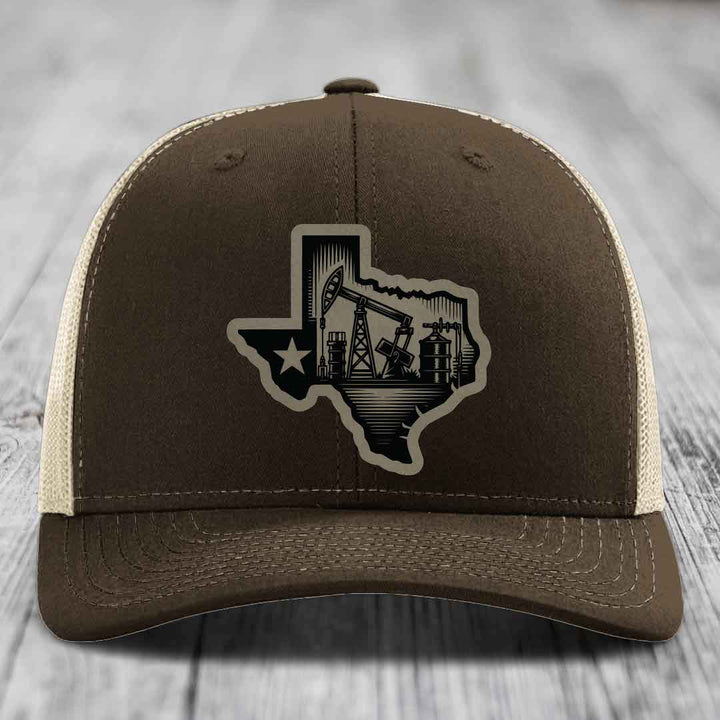 Brown trucker hat with Texas oilfield patch featuring pumpjacks and star design.