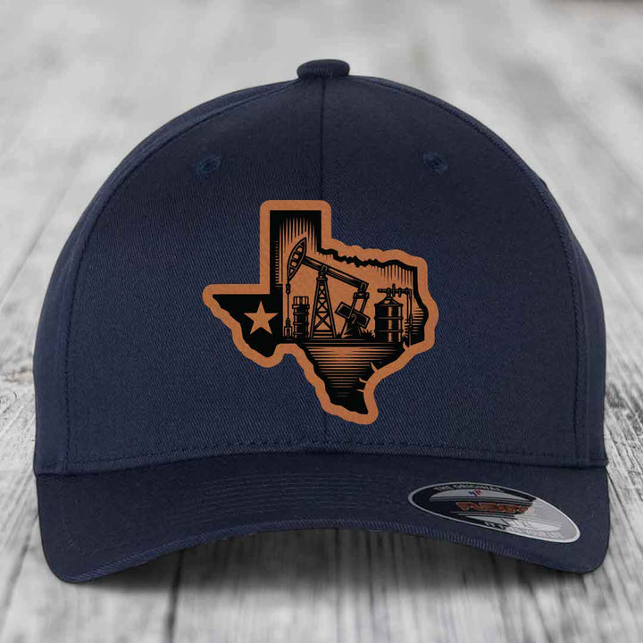 Dark blue baseball cap with Texas oilfield patch featuring pumpjacks and star.