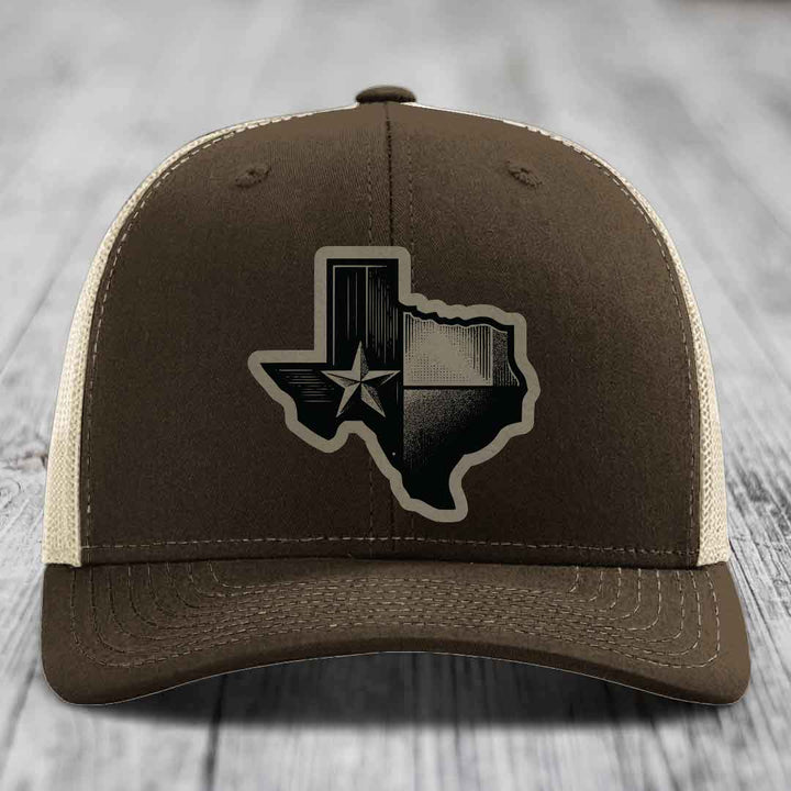 Brown trucker hat with Texas-shaped patch featuring star and black-and-white design.