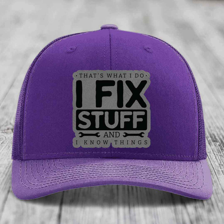 Purple trucker hat with gray and black patch reading &