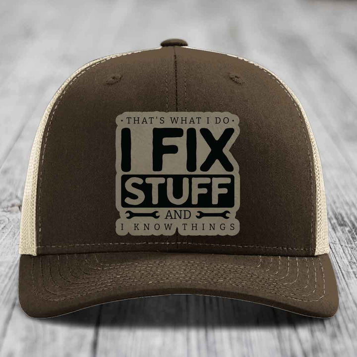 Brown trucker hat with beige mesh back and embroidered patch reading &