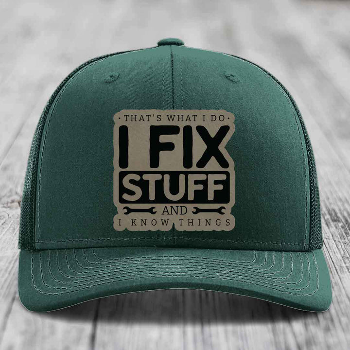 Green trucker hat with a beige leatherette patch that reads &