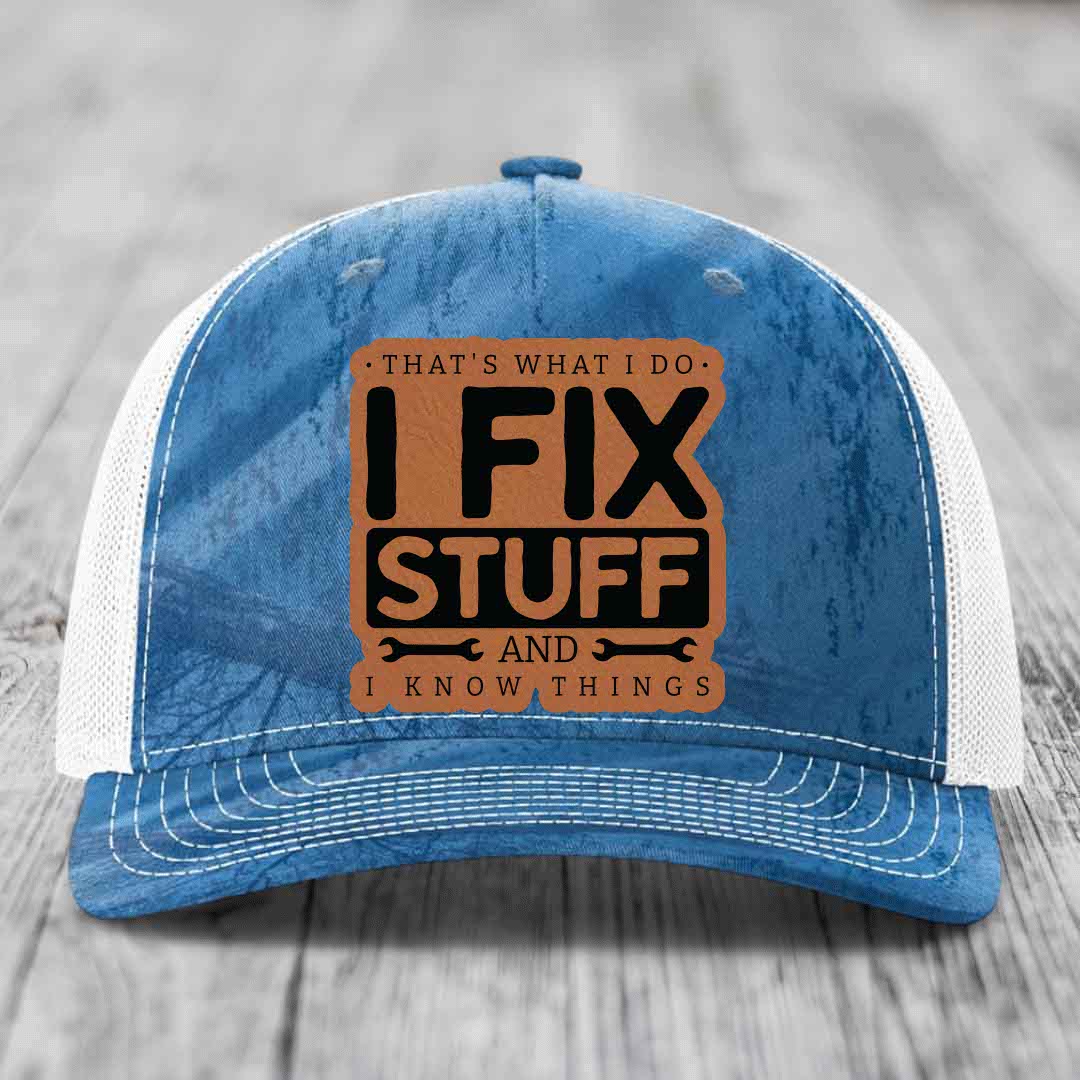 Blue and white trucker hat with brown leather patch reading &