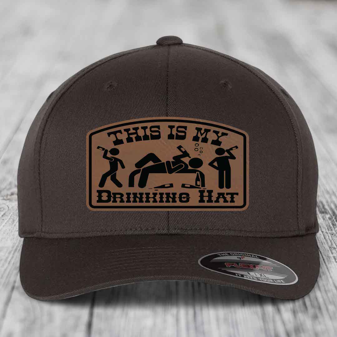 Dark brown baseball cap with a tan leatherette patch reading &