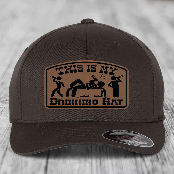 Dark brown baseball cap with a tan leatherette patch reading &