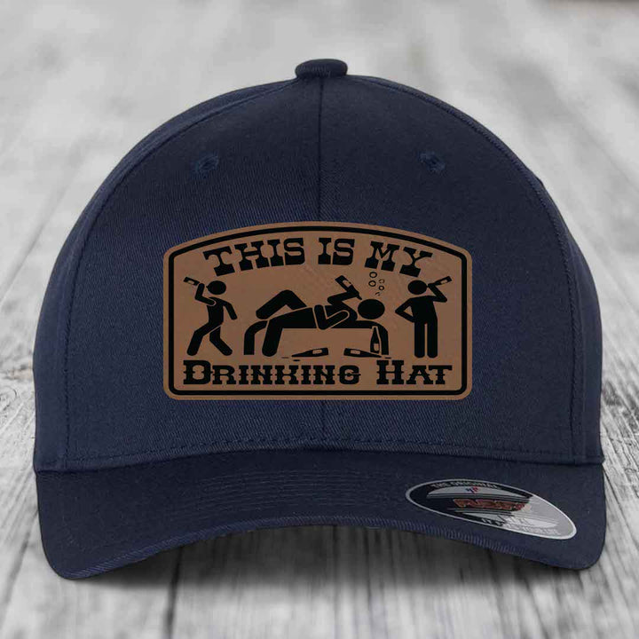 Dark blue baseball cap with a tan leatherette patch reading &