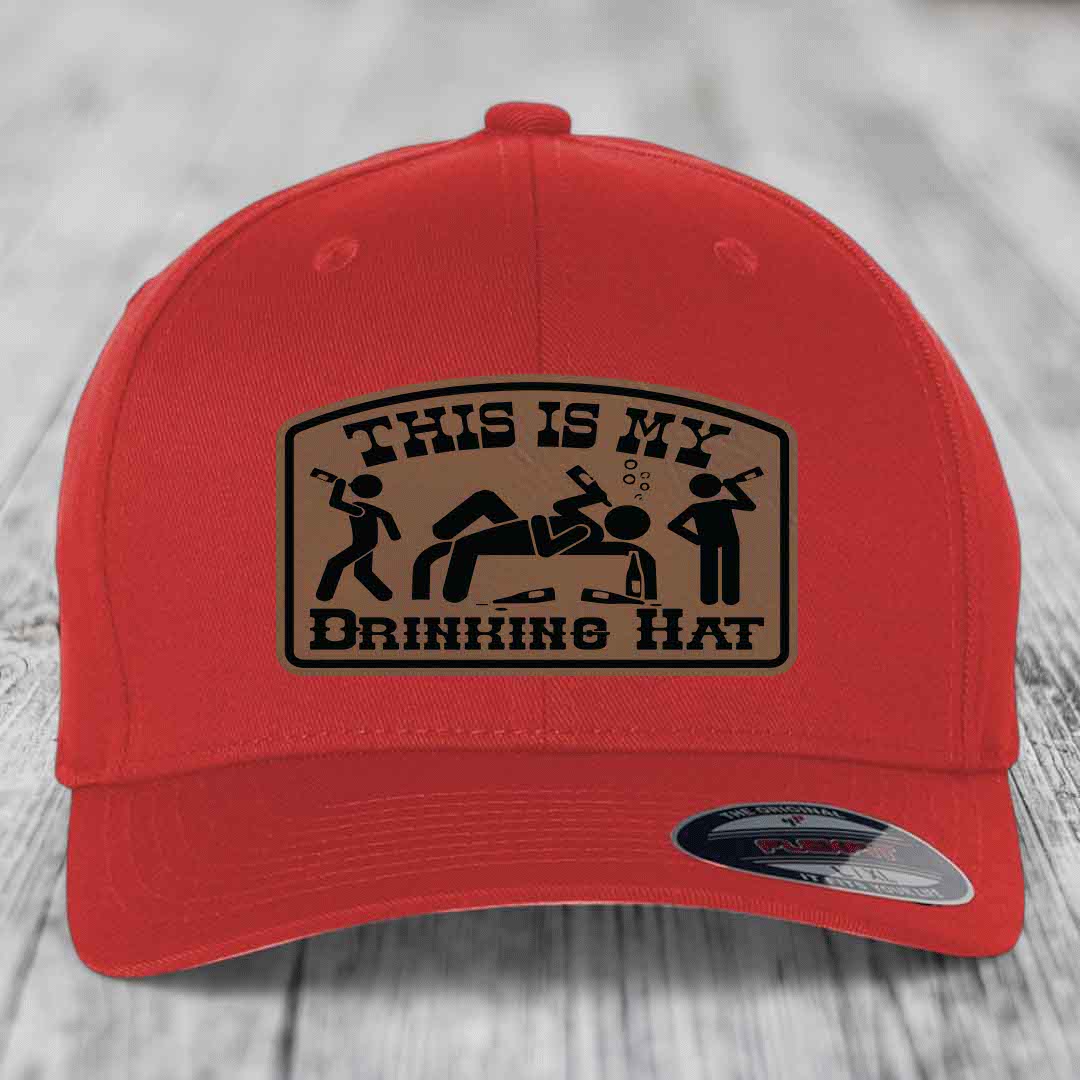 Red baseball cap with a brown leatherette patch reading &