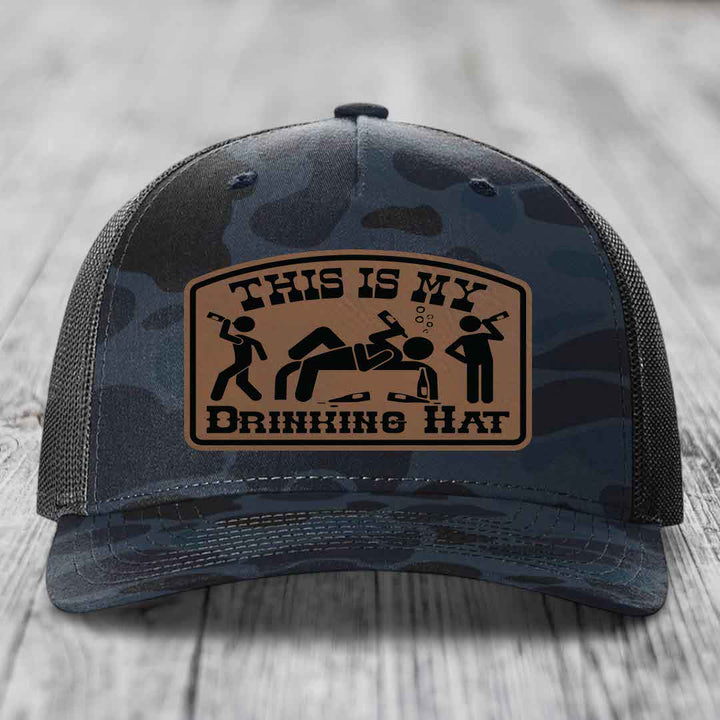 Camouflage trucker hat with brown leather patch reading &