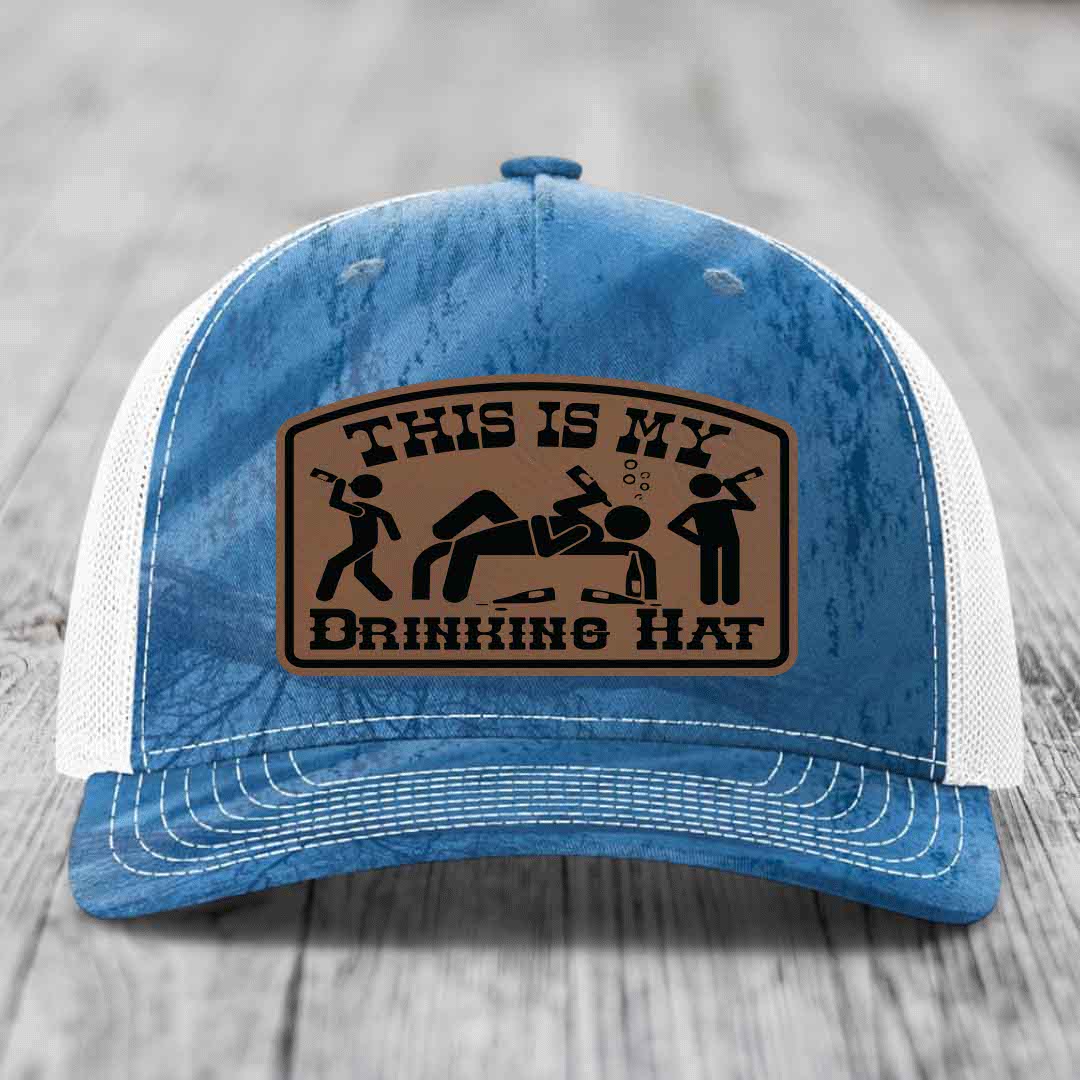 Blue and white trucker hat with a brown leather patch that reads &