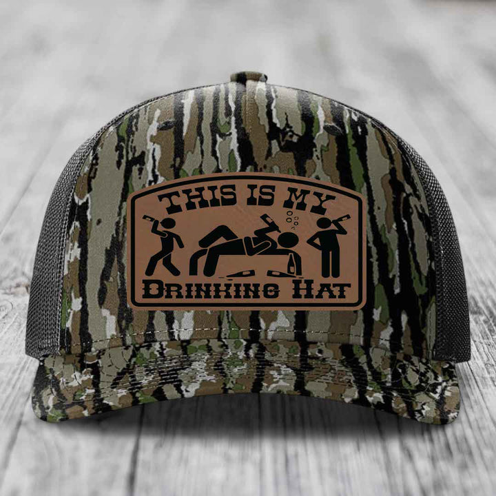 Camouflage trucker hat with brown leather patch reading &