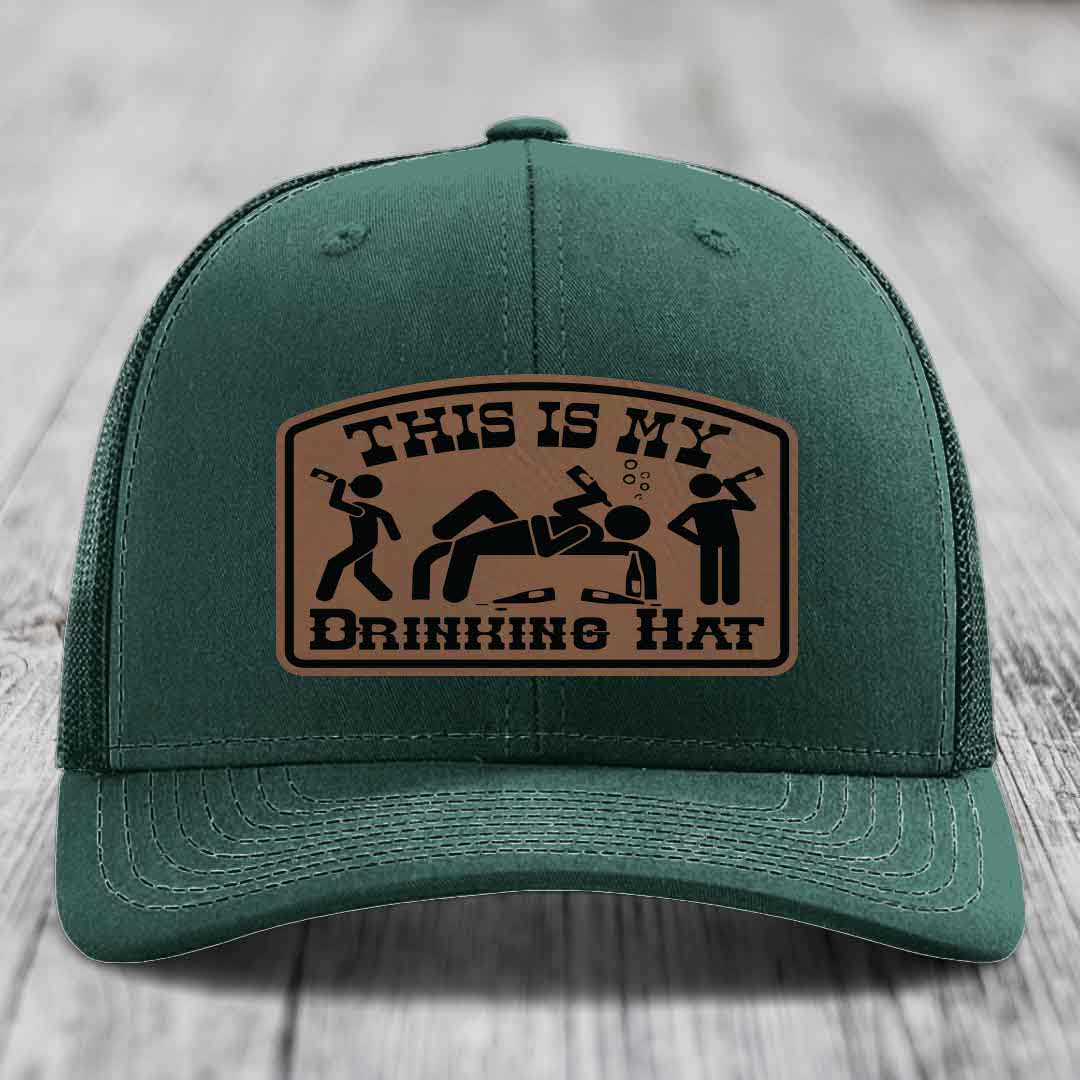 Green trucker hat with brown leather patch reading &