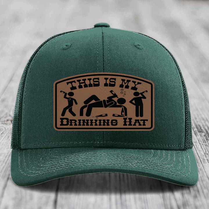 Green trucker hat with brown leather patch reading &