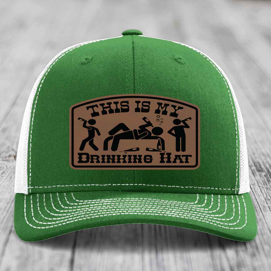 Green trucker hat with white mesh back and stitching, featuring a brown leatherette patch that reads &