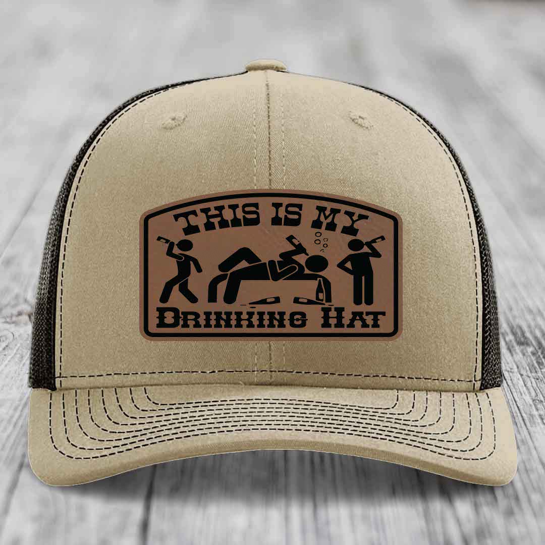 Beige trucker hat with brown leather patch reading &