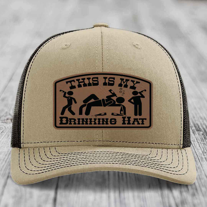 Beige trucker hat with brown leather patch reading &