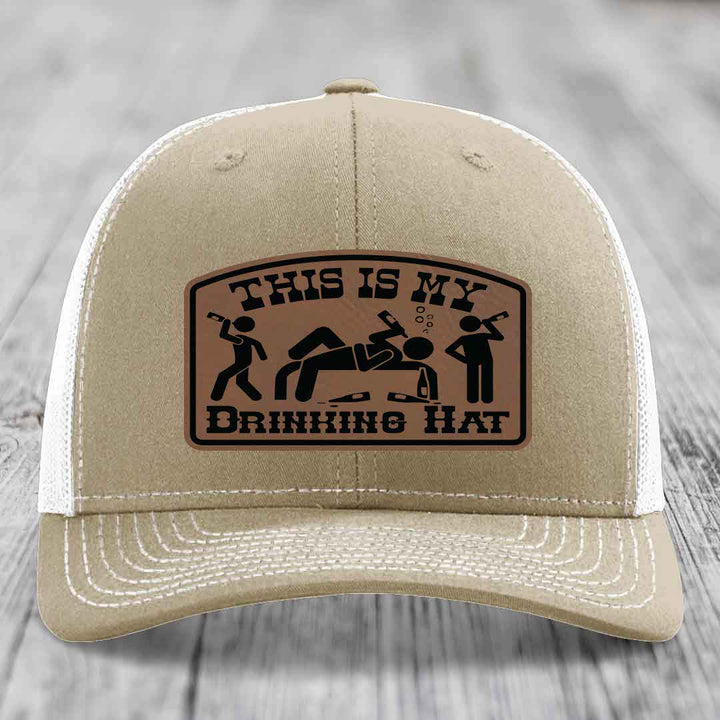 Tan trucker hat with brown leather patch reading &