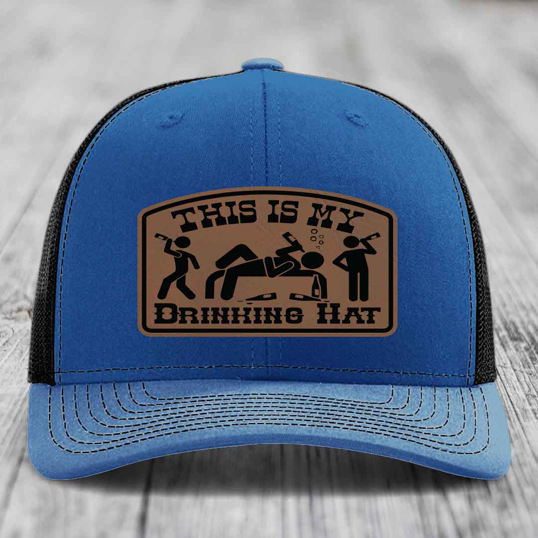 Blue trucker hat with brown leather patch reading &