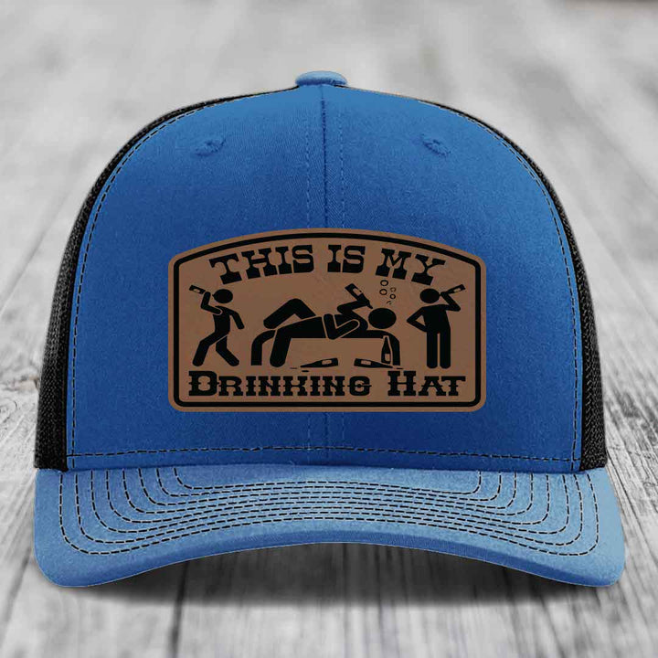 Blue trucker hat with brown leather patch reading &