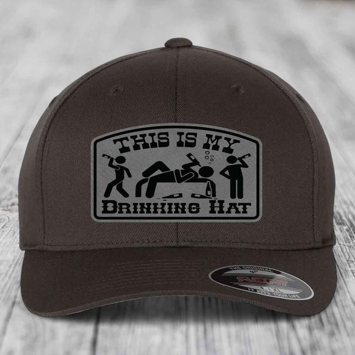 Brown baseball cap with a gray patch reading &