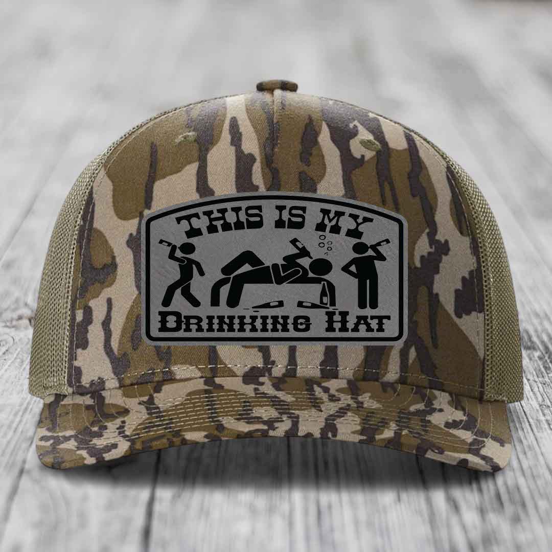Camouflage trucker hat with a gray patch reading &