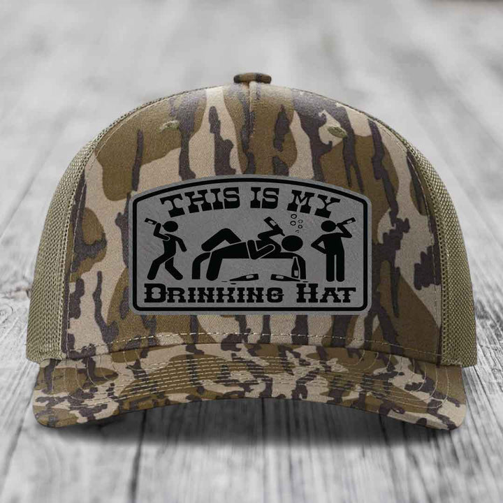 Camouflage trucker hat with a gray patch reading &