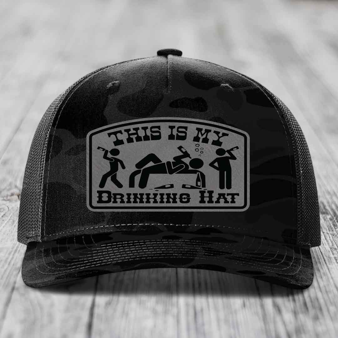 Black camouflage trucker hat with a rectangular patch reading &