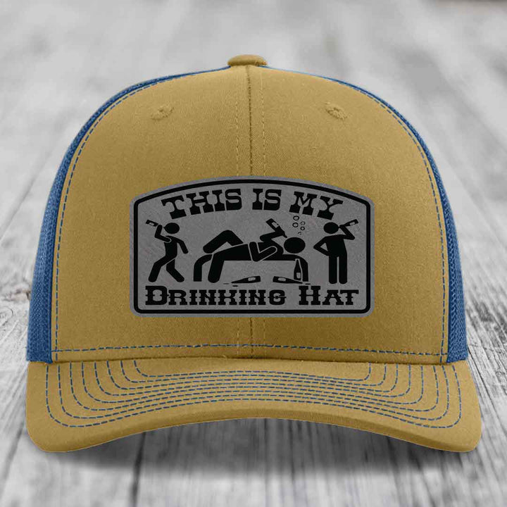 Tan and blue trucker hat with a black and grey &