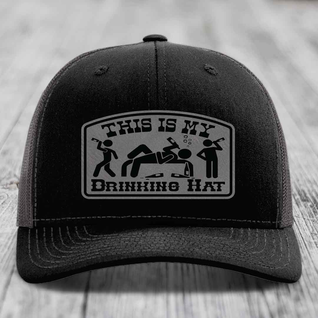 Black trucker hat with a gray patch that reads &