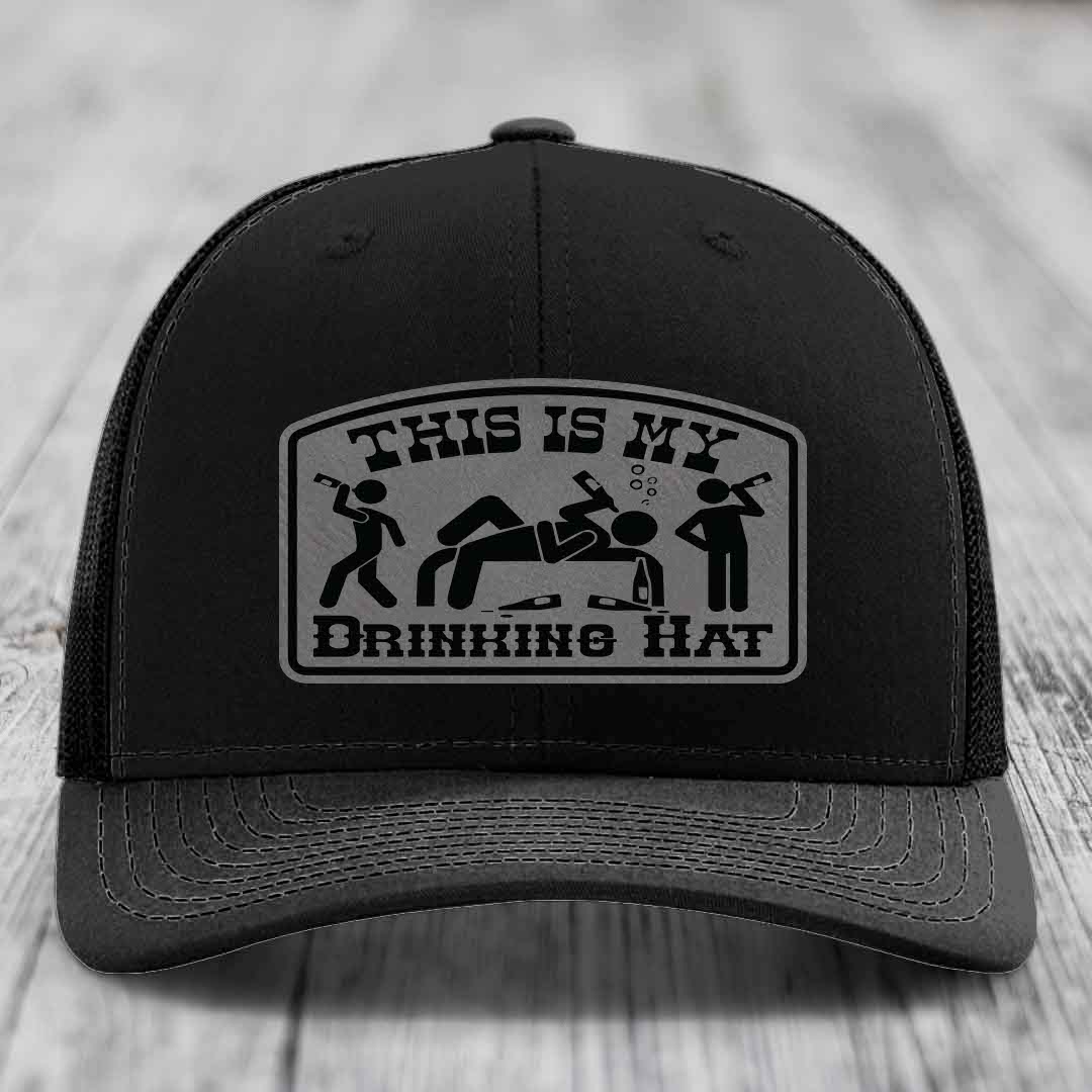Black trucker hat with a gray patch that reads &