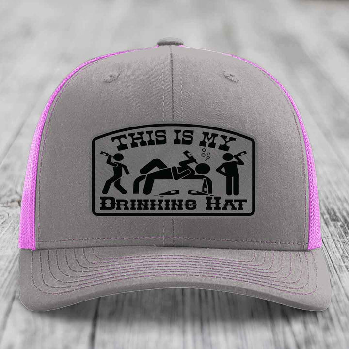 Grey trucker hat with pink mesh sides and black &