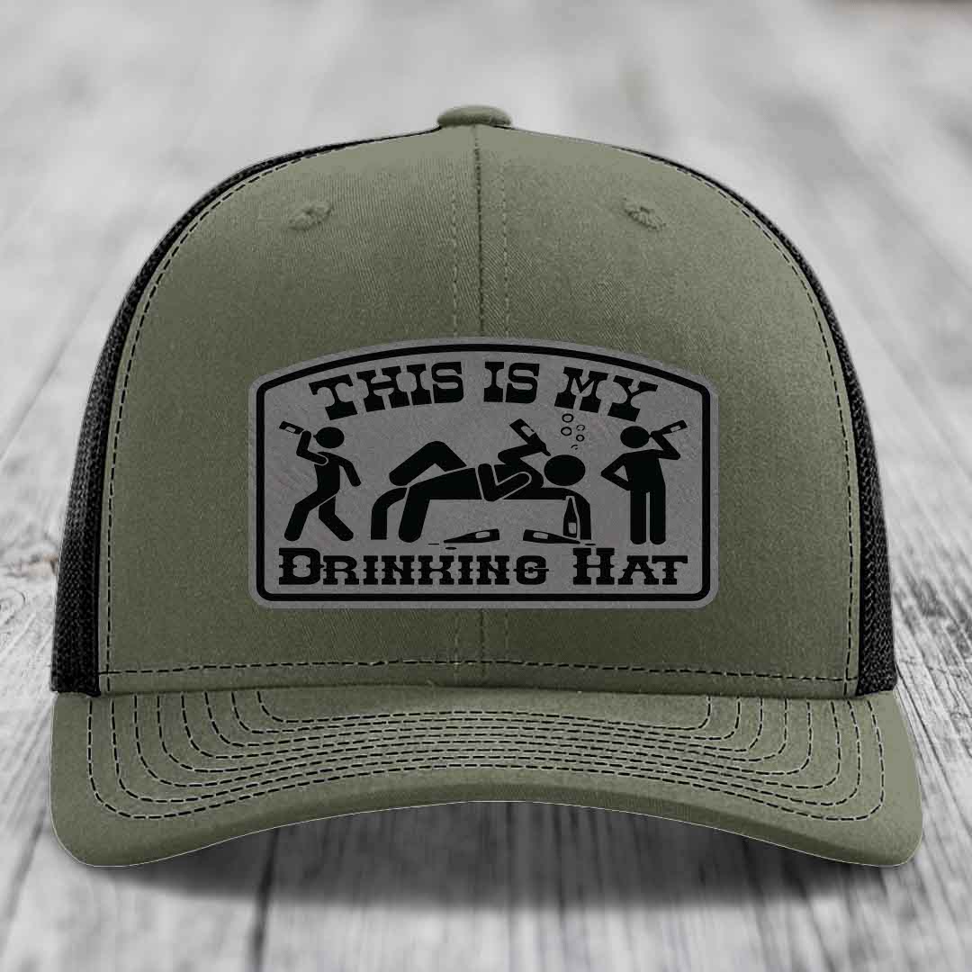 Olive green trucker hat with black mesh back and a rectangular patch that reads &