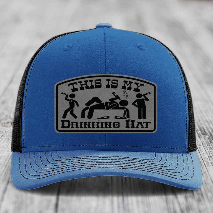 Blue trucker hat with black mesh back and gray patch reading &