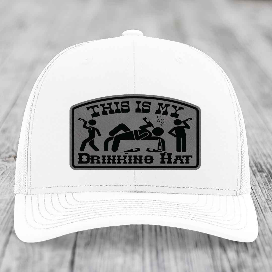 White trucker hat with black leatherette patch reading &