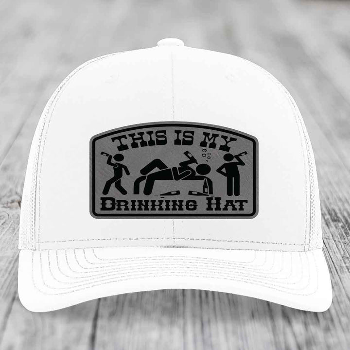 White trucker hat with black leatherette patch reading &