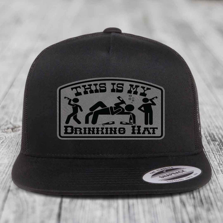 Black trucker hat with a gray patch that reads &