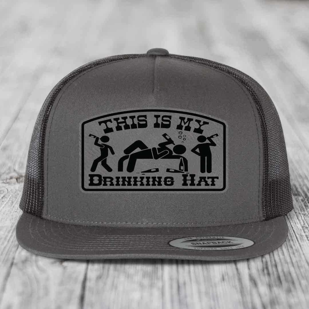 Grey trucker hat with black patch reading &