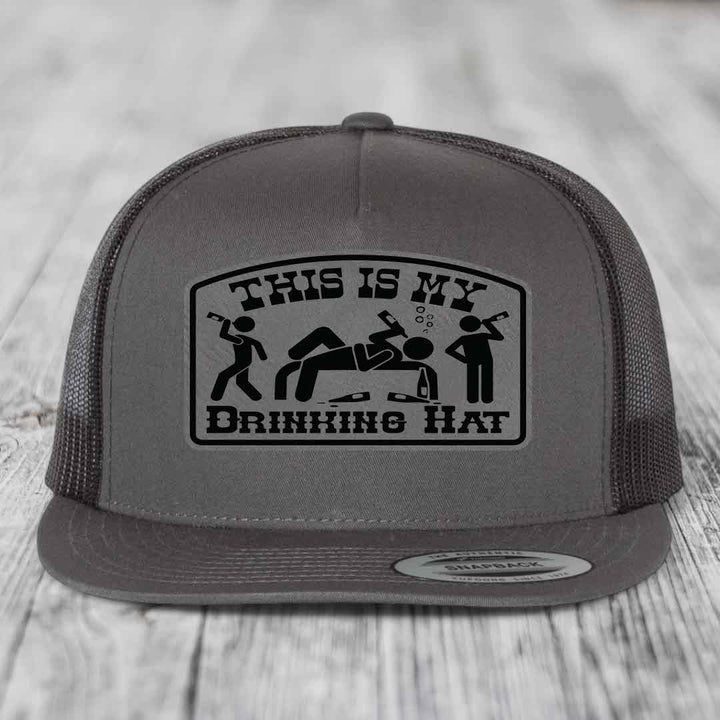Grey trucker hat with black patch reading &
