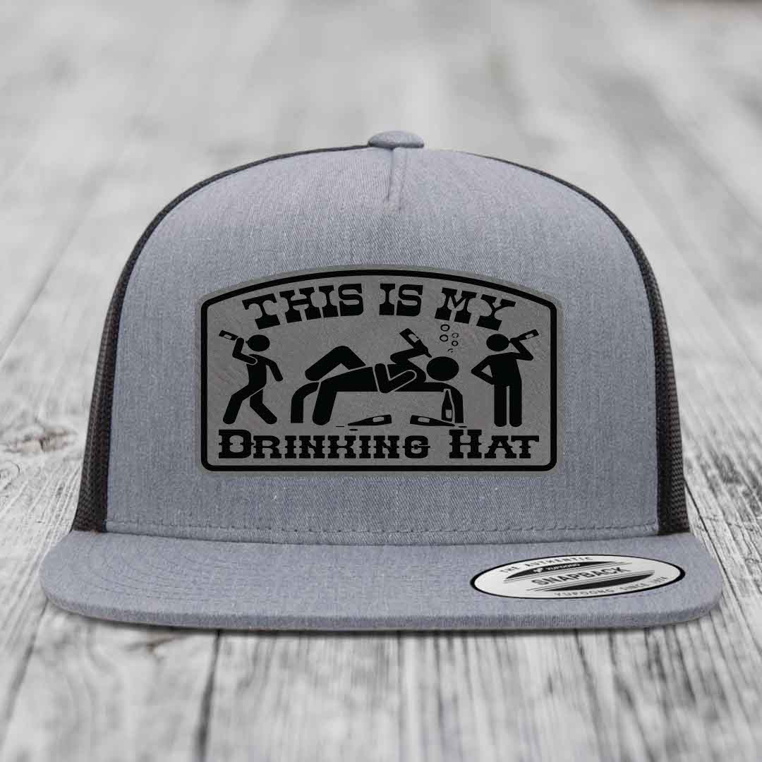 Grey trucker hat with black patch reading &