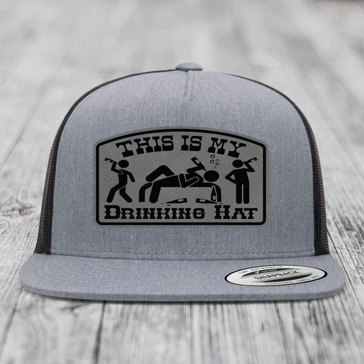 Grey trucker hat with black patch reading &