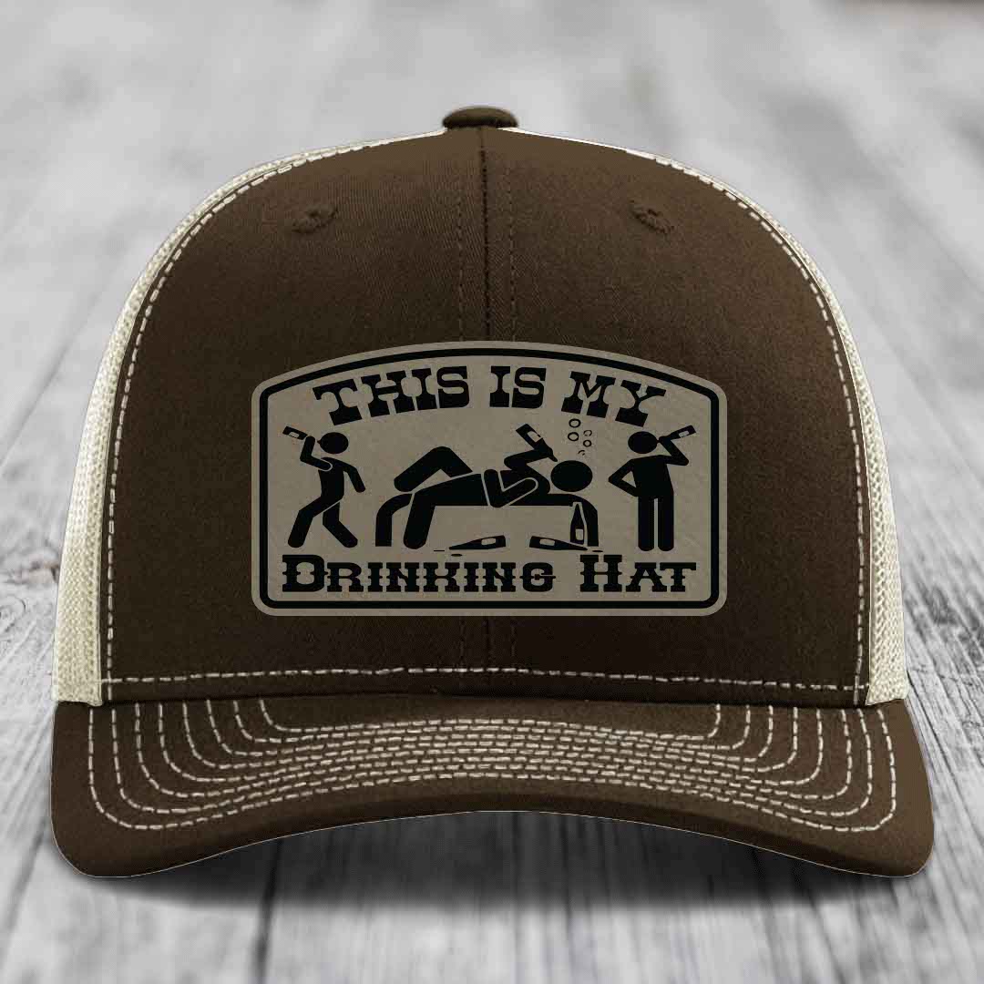 Brown trucker hat with white stitching and a patch reading &