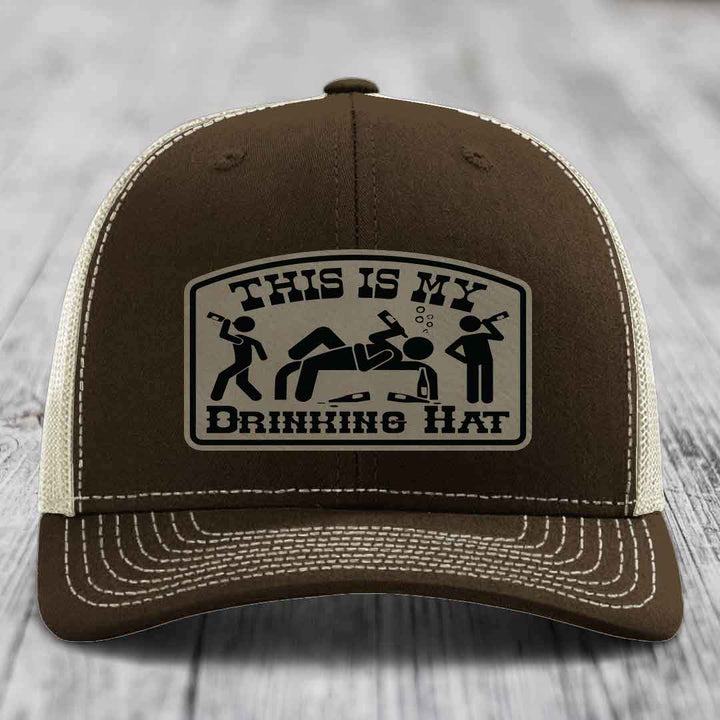 Brown trucker hat with white stitching and a patch reading &