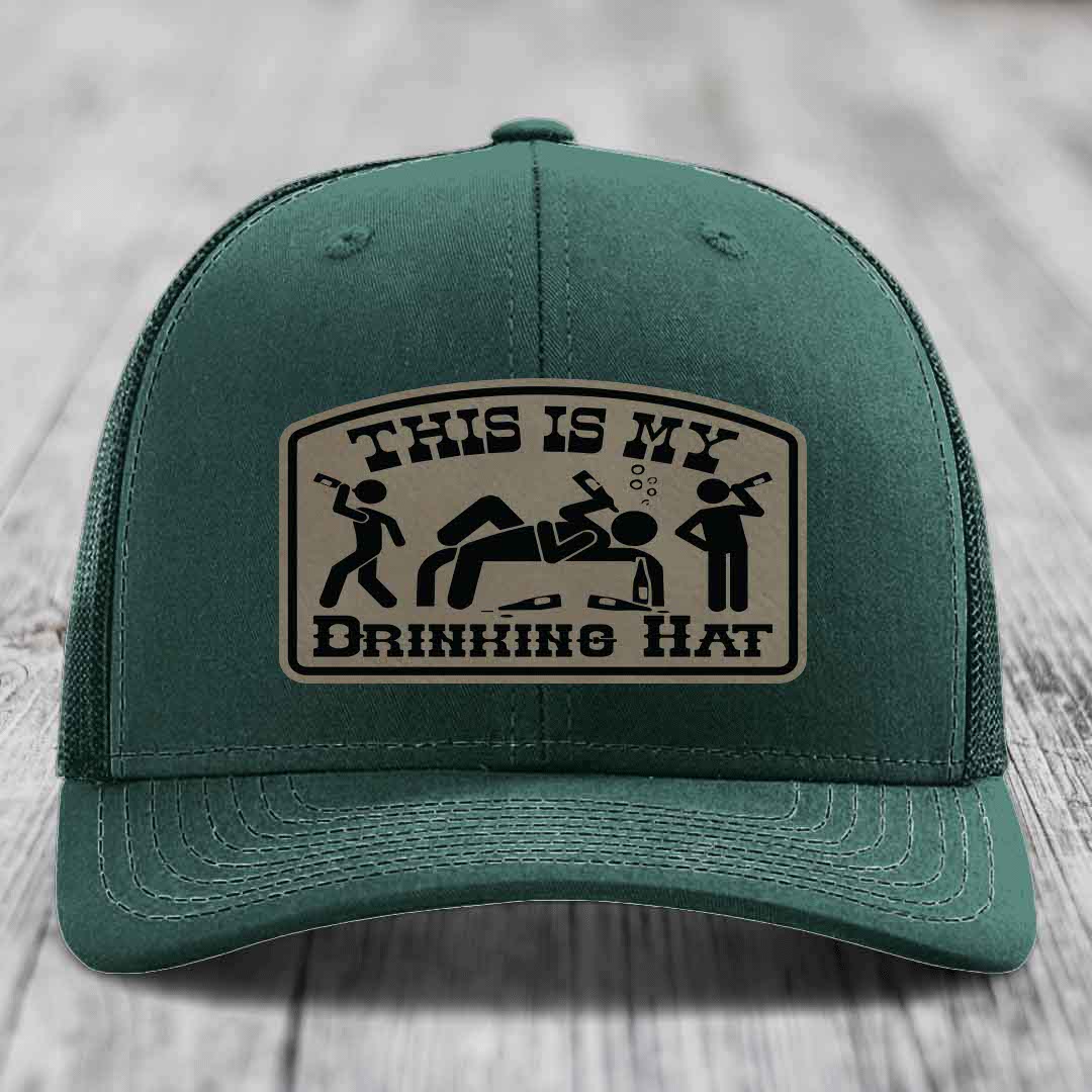 Green trucker hat with a beige leatherette patch that reads &