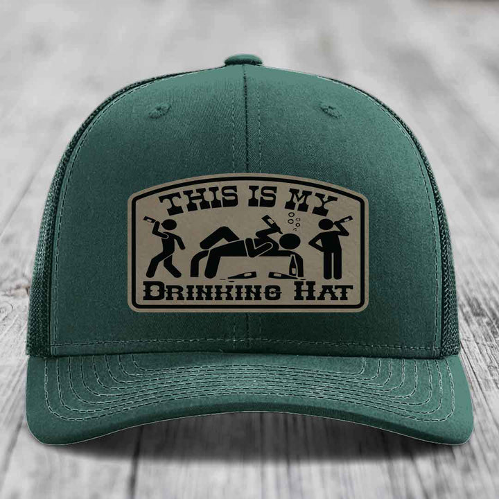 Green trucker hat with a beige leatherette patch that reads &