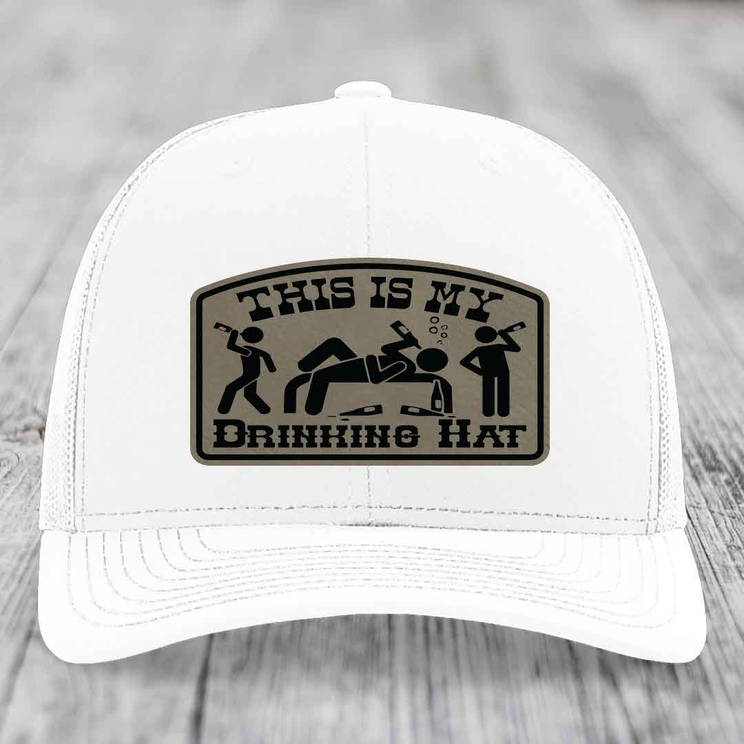 White trucker hat with a brown leatherette patch reading &