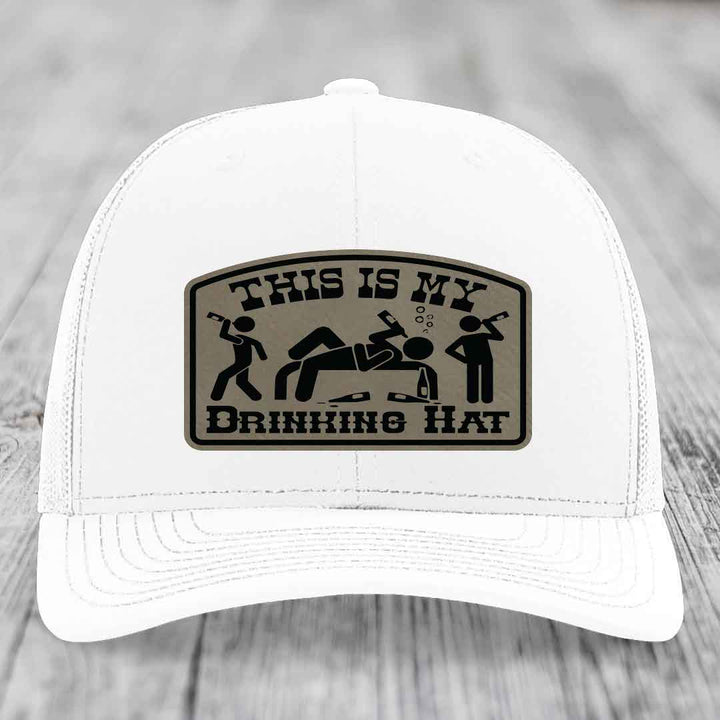 White trucker hat with a brown leatherette patch reading &
